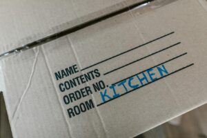 Cardboard moving box labeled "Kitchen"
