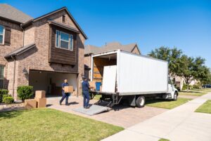 Moving truck parked outside a new suburban home in Katy TX on a sunny moving day